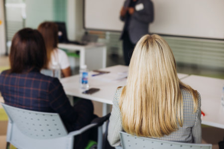Audience team on master class seminar, working together during contest competition in the auditorium class, corporate workshop, company coworkers and colleagues listen to lecturer on a conferenceの写真素材