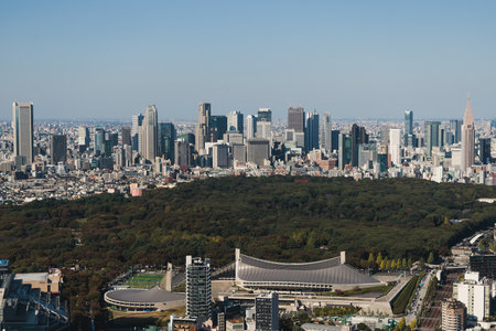 Beautiful super wide aerial view of Tokyo, Japan, rooftops and skyscrapers, with skyline and city scenery, seen from the observation deck in a sunny day with a blue sky, Tokyo Metropolitan urban areaの写真素材