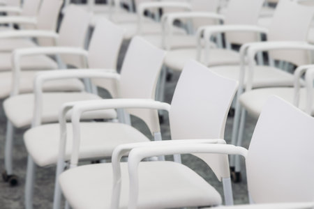 Audience at the modern conference hall listens to panel discussion, people on a congress together listen to speaker on stage at convention, plenary session at business seminar, venue for presentationの写真素材