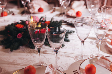Beautiful table decoration for luxury event in pink and gold, cutlery and tableware, banquet hall arrangement decor, celebration in restaurant with flowers, candles on a wedding reception partyの写真素材