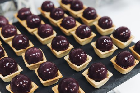 Catering table, beautifully decorated banquet with variety of different food snacks appetizers on...
