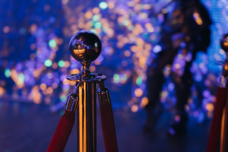 Red carpet with ropes and golden barriers on a luxury party entrance, cinema premiere film festival event award gala ceremony, wealthy rich guests arriving at event venue, indoor decoration elementsの写真素材