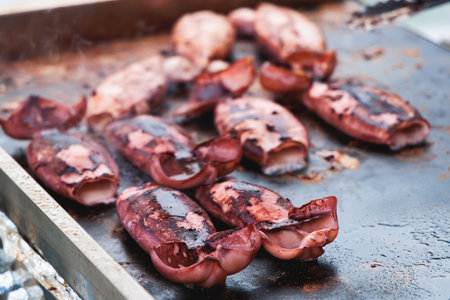 Ikayaki, Grilled roasted Squid with sauce - popular Japanese Street Food, variety of different traditional food snack selection in Tokyo, Japan, street market with local vendor stalls cookingの写真素材