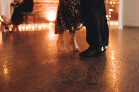 Couples dancing traditional latin argentinian dance milonga in the ballroom, tango salsa bachata kizomba lesson in red and purple lights, evening dance school class festivalの写真素材