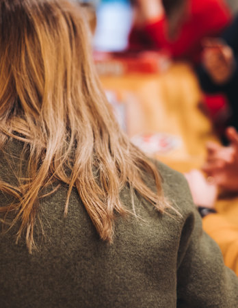 Process of playing tabletop board game on the table, fun with friends and family in room indoors, board game party concept, group of students adults play board games, roll the dice on game mapの写真素材