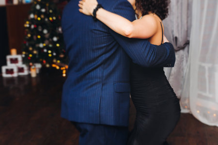 Couples dancing traditional latin argentinian dance milonga in a ballroom, tango salsa bachata kizomba lesson in red and purple lights, performance rehearsal, evening dance school class festivalの写真素材