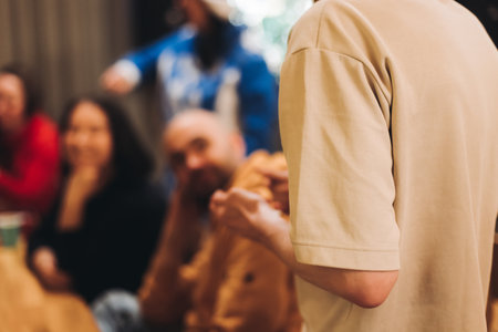 Process of playing tabletop board game on the table, fun with friends and family in room indoors, board game party concept, company group of students adults play board games, roll the dice on game mapの写真素材