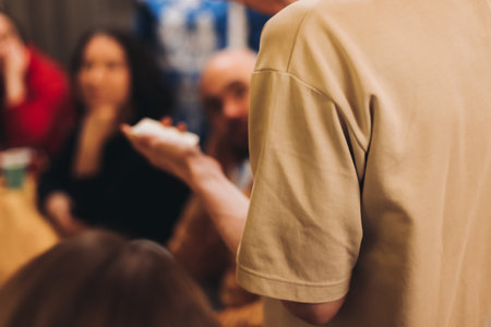 Process of playing tabletop board game on the table, fun with friends and family in room indoors, board game party concept, company group of students adults play board games, roll the dice on game mapの写真素材