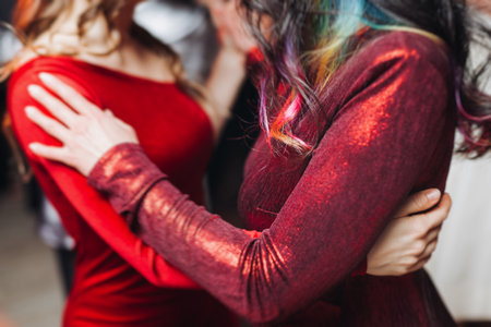 Couples dancing traditional latin argentinian dance milonga in a ballroom, tango salsa bachata kizomba lesson in red and purple lights, performance rehearsal, evening dance school class festivalの写真素材