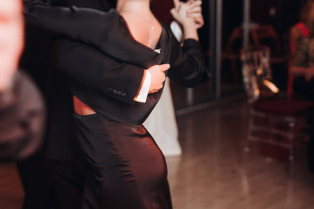 Couples dancing traditional latin argentinian dance milonga in a ballroom, tango salsa bachata lesson in red and purple lights, performance rehearsal, evening dance school class festivalの写真素材