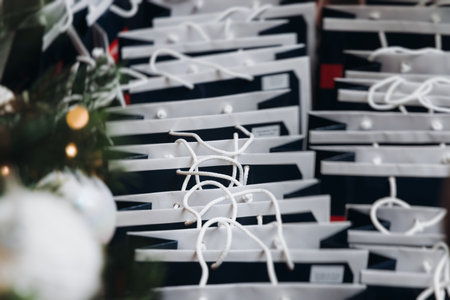 New Year corporate gifts and souvenirs presentation for company employees, Christmas party presents exchange, gift bag package for conference participants, gift giving at office work, black paper bagsの写真素材