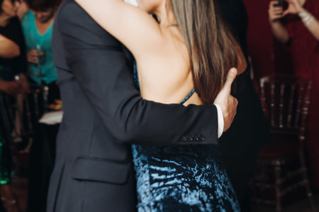 Couples dancing traditional latin argentinian dance milonga in a ballroom, tango salsa bachata kizomba lesson in red and purple lights, performance rehearsal, evening dance school class festivalの写真素材