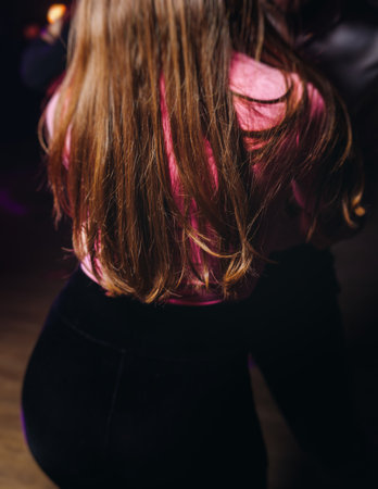 Couples dancing traditional latin argentinian dance milonga in a ballroom, tango salsa bachata kizomba lesson in red and purple lights, performance rehearsal, evening dance school class festivalの写真素材