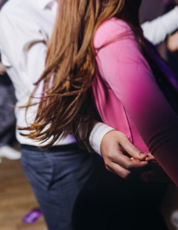 Couples dancing traditional latin argentinian dance milonga in a ballroom, tango salsa bachata kizomba lesson in red and purple lights, performance rehearsal, evening dance school class festivalの写真素材