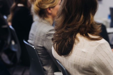 Audience at the modern conference hall listens to panel discussion, people on a congress together listen to speaker on stage at convention, plenary session at business seminar, venue for presentationの写真素材