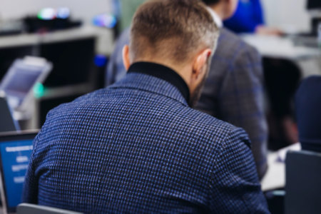 Audience at the modern conference hall listens to panel discussion, people on a congress together listen to speaker on stage at convention, plenary session at business seminar, venue for presentationの写真素材