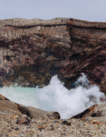 Mount Aso Nakadake volcano crater, Aso-San, caldera, Aso-Kuju National Park hiking, Kyushu island region, Kumamoto prefecture, Japan, eruption with steam and smoke, volcanic desert landscape viewの写真素材