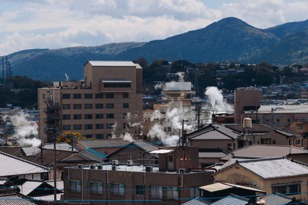 Beppu, Japan, city panorama skyline, Kannawa onsen distict, Oita prefecture, Kyushu island region,, Yukemuri observation deck, rising hot steam from onsen ryokan bath houses, Beppu resort hot springsの写真素材