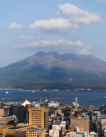 View of Kagoshima city, Japan, Kagoshima prefecture, Kyushu island region, with Sakurajima island volcano and Kagoshima bay, seen from Shiroyama park mountain observatory in a spring day with blue skyの写真素材