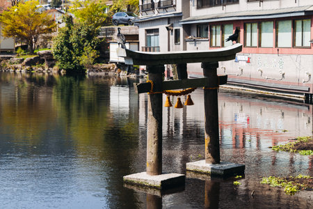 Kinrin lake in Yufuin town, Kinrin-ko lake, Oita prefecture, Japan, hot spring onsen resort town, with mount Yufu, Kyushu island region, rural mountain landscape, a spring day with a blue skyの写真素材