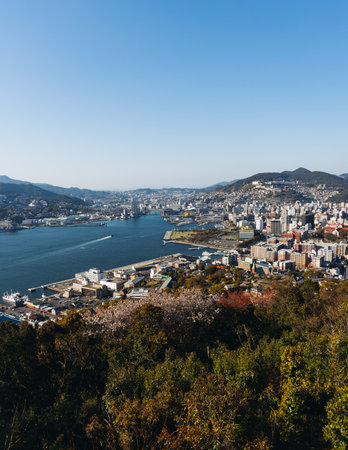 Nagasaki panorama, Japan, beautiful aerial view, with city skyline, port and mountains, seen from Nabekammuri mount, in a spring sunny day with a blue sky, Nagasaki prefecture, Kyushu island regionの写真素材