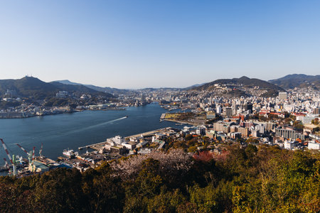 Nagasaki panorama, Japan, beautiful aerial view, with city skyline, port and mountains, seen from Nabekammuri mount, in a spring sunny day with a blue sky, Nagasaki prefecture, Kyushu island regionの写真素材