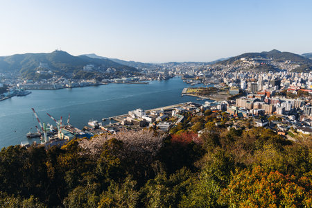 Nagasaki panorama, Japan, beautiful aerial view, with city skyline, port and mountains, seen from Nabekammuri mount, in a spring sunny day with a blue sky, Nagasaki prefecture, Kyushu island regionの写真素材