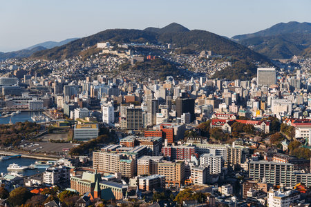 Nagasaki panorama, Japan, beautiful aerial view, with city skyline, port and mountains, seen from Nabekammuri mount, in a spring sunny day with a blue sky, Nagasaki prefecture, Kyushu island regionの写真素材