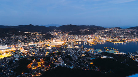 Nagasaki night panorama, Japan, aerial view, city skyline, port and mountains, seen from Inasa mount, Inasayama park, city illumination, Nagasaki prefecture, Kyushu island region, ropeway cable carの写真素材