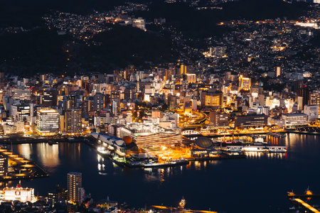 Nagasaki night panorama, Japan, aerial view, city skyline, port and mountains, seen from Inasa mount, Inasayama park, city illumination, Nagasaki prefecture, Kyushu island region, ropeway cable carの写真素材