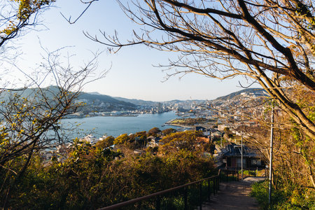 Nagasaki panorama, Japan, beautiful aerial view, with city skyline, port and mountains, seen from Nabekammuri mount, in a spring sunny day with a blue sky, Nagasaki prefecture, Kyushu island regionの写真素材