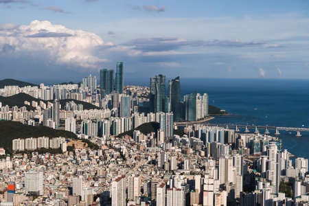 Busan city panorama beautiful skyline view from Hwangnyeongsan mountain observatory, Busan port, Gwangan bridge and harbor bay, sunny day, travel to Republic of Koreaの写真素材