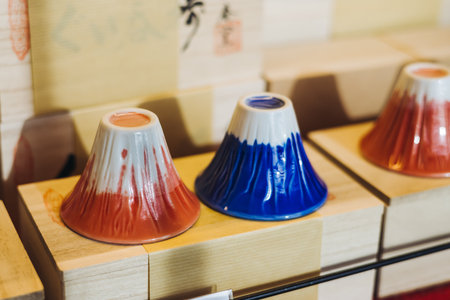 Traditional Japanese tourist souvenirs and gifts from Tokyo, Japan, with mount Fuji figures, refrigerator magnets, Maneki-neko beckoning cat figurine, key ring keychain, in a local vendor gift shopの写真素材