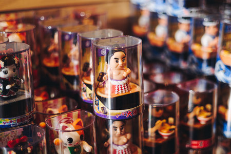 Traditional Japanese tourist souvenirs and gifts from Tokyo, Japan, with mount Fuji figures, refrigerator magnets, Maneki-neko beckoning cat figurine, key ring keychain, in a local vendor gift shopの写真素材