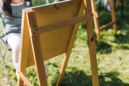 Kids drawing at plein air, group class of talented children with painting easel and wooden canvas during lesson of watercolor painting outdoors in summerの写真素材