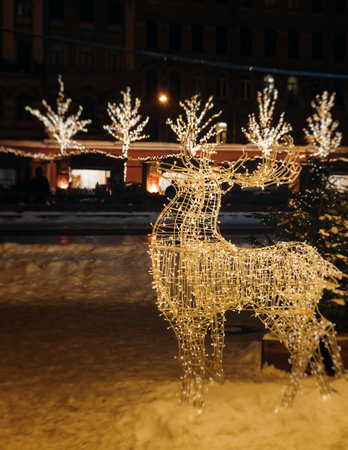 New Year and Christmas in Russia, glowing decor decoration in a winter snowy street, with night decor illumination, city outdoor decorations, Saint-Petersburg, christmas tree and garland lightの写真素材