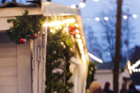 Christmas market with illuminated food stalls, gift shops and kiosks, New Year outdoor fair...