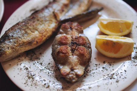 Montenegrin cuisine, fish assortment platter, fried grilled crucian carp steak, roasted pastrmka and...