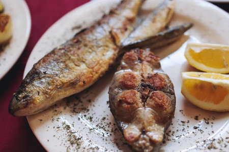 Montenegrin cuisine, fish assortment platter, fried grilled crucian carp steak, roasted pastrmka and...