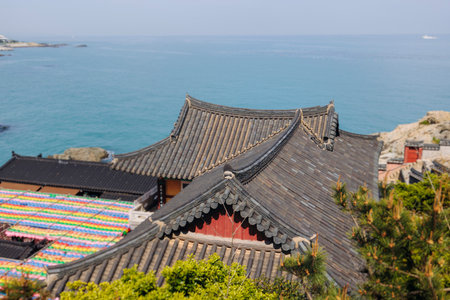 Busan, South Korea, Haedong Yonggungsa Temple view, Buddhist temple in Gijang-gun, coastal sea landscape with shrine facade exterior, Gijang County, Northern Busan, Yeongnam region, sunny spring dayの写真素材