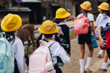 Group of school children students outdoor excursion, guided tour in the city with guide, docent with...