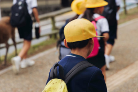 Group of school children students outdoor excursion, guided tour in the city with guide, docent with...