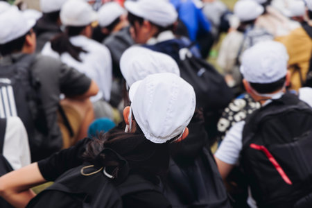 Group of school children students outdoor excursion, guided tour in the city with guide, docent with...