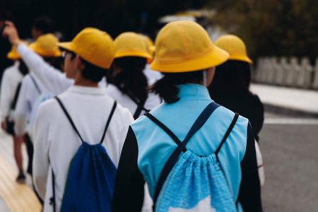 Group of school children students outdoor excursion, guided tour in the city with guide, docent with...