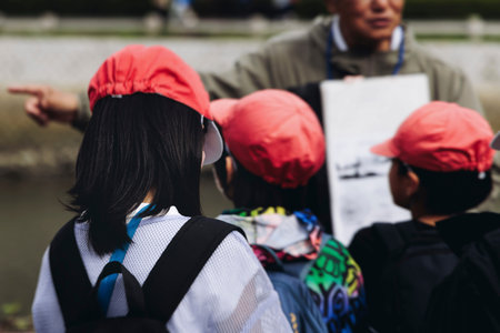 Group of school children students outdoor excursion, guided tour in the city with guide, docent with...
