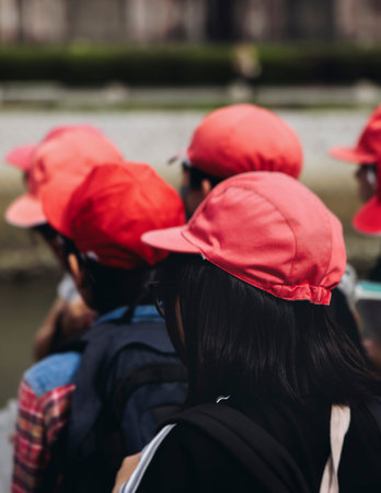 Group of school children students outdoor excursion, guided tour in the city with guide, docent with...
