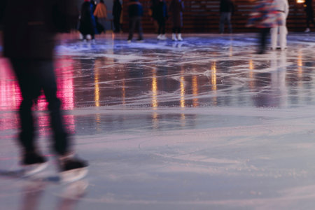 Ice skating on the ice rink arena with people, skating rink surface, ice skating in winter city,...