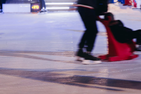 Ice skating on the ice rink arena with people, skating rink surface, ice skating in winter city,...