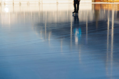 Ice skating on the ice rink arena with people, skating rink surface, ice skating in winter city,...
