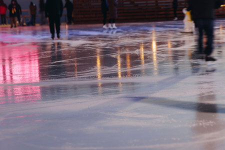 Ice skating on the ice rink arena with people, skating rink surface, ice skating in winter city,...